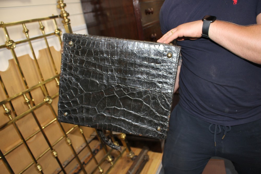 An early 20th century black crocodile toilet case, 40 x 33 x 18cm